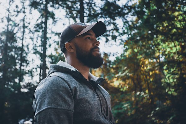 Bearded man standing in the woods