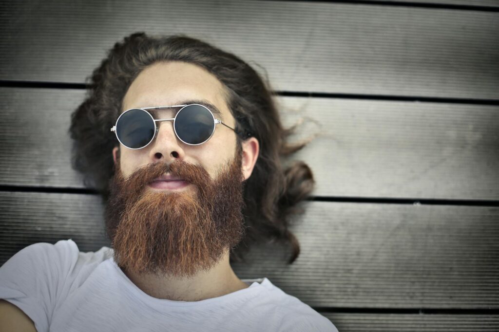 man in white shirt wearing silver framed sunglasses